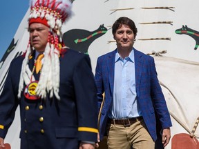 Prime Minister Justin Trudeau and Siksika Nation Nioksskaistamik (Chief) Ouray Crowfoot walk out of a tepee where they held a sitting prior to signing a land agreement at the historical site of Treaty Flats on Thursday, June 2, 2022.