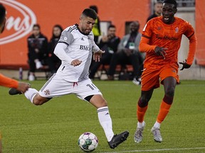 Toronto FC midfielder Alejandro Pozuelo (10) kicks the ball against Forge FC defender Ashtone Morgan.