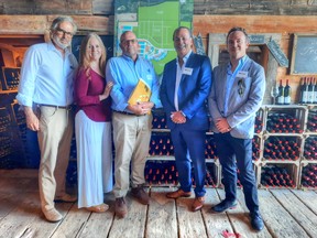 Saxe Brickenden and Sherri Karlo of Karlo Estate winery, Mayor Steve Ferguson, Bill Daniell, president of Kaitlin Corporation and Devon Daniell, director of business development for Kaitlin at the grand opening of Cork&Vine in Wellington, Ont SUPPLIED