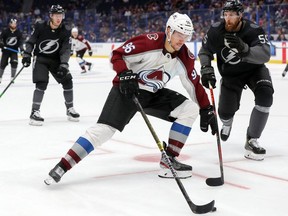 Mikko Rantanen #96 of the Colorado Avalanche skates past Braydon Coburn #55 of the Tampa Bay Lightning during the third period at the Amalie Arena on October 19, 2019 in Tampa, Florida.