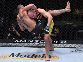 In this handout image provided by UFC, Glover Teixeira (R) of Brazil takes down Thiago Santos of Brazil in a light heavyweight fight during the UFC Fight Night event at UFC APEX on November 07, 2020 in Las Vegas, Nevada.
