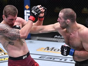 In this handout image provided by UFC, (R-L) Sean Strickland punches Brendan Allen in a 195-pound catchweight fight during the UFC Fight Night event at UFC APEX on November 14, 2020 in Las Vegas, Nevada.