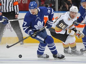 Timothy Liljegren of the Toronto Maple Leafs handles the puck against William Carrier of the Vegas Golden Knights at Scotiabank Arena on November 2, 2021 in Toronto, Ontario, Canada.