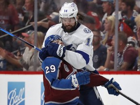 Pat Maroon of the Tampa Bay Lightning takes down Nathan MacKinnon of the Colorado Avalanche after the play in the second period of Game Five of the 2022 Stanley Cup Final at Ball Arena on June 24, 2022 in Denver.