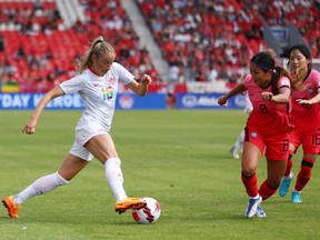 Janine Beckie #16 of Canada dribbles the ball as Sohyun Cho #8 of South Korea defends during a friendly match at BMO Field on June 26, 2022.