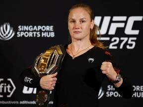 Flyweight champion Valentina Shevchenko of Kyrgyzstan poses with her belt after speaking to media ahead of her title defense bout against Taila Santos of Brazil during UFC 275 Media Day at Mandarin Oriental on June 08, 2022 in Singapore.