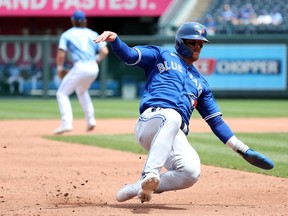 KANSAS CITY, MISSOURI - JUNE 08:  Cavan Biggio #8 of the Toronto Blue Jays slides into third base during the game against the Kansas City Royals at Kauffman Stadium on June 08, 2022 in Kansas City, Missouri.