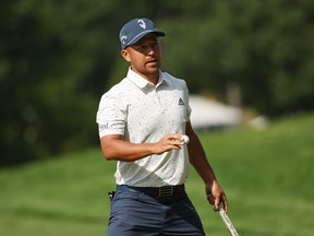 Xander Schauffele of the United States waves on the 14th green during round one of the 122nd U.S. Open Championship at The Country Club on June 16, 2022 in Brookline, Massachusetts.