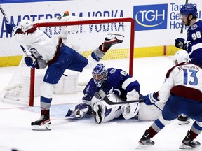 Nazem Kadri #91 of the Colorado Avalanche scores a goal against Andrei Vasilevskiy #88 of the Tampa Bay Lightning to win 3-2 in overtime in Game Four of the 2022 NHL Stanley Cup Final at Amalie Arena on June 22, 2022 in Tampa, Florida.