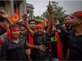 Protestors affiliated with various Hindu organizations wave flags and shout slogans during a demonstration against the killing of Kanhaiya Lal on June 29, 2022 in Bengaluru, India.?The beheading of Kanhaiya Lal, 48, a tailor in the western Indian city of Udaipur by two Muslim men in retaliation for his support of controversial remarks made by the Bharatiya Janata Party (BJP) politician Nupur Sharma on the Prophet Muhammad, has sparked religious tension with suspension of internet services and the barring of large gatherings on the streets of the desert city.