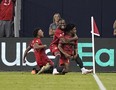 Toronto FC midfielder Ralph Priso (right) celebrates with forward Ayo Akinola (20) after scoring the match winning goal against Atlanta United FC.