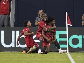 Toronto FC midfielder Ralph Priso (right) celebrates with forward Ayo Akinola (20) after scoring the match winning goal against Atlanta United FC.