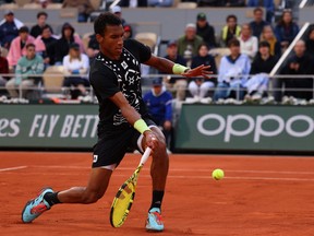 Canada's Felix Auger-Aliassime returns to Spain's Rafael Nadal during their men's singles match on day eight of the Roland-Garros Open tennis tournament at the Court Philippe-Chatrier in Paris on May 29, 2022.