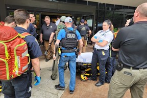 In this handout photo courtesy of Tulsa Police Department taken on June 1, 2022, Police officers and emergency personnel respond to a call about a man armed with a rifle at the Natalie Building at St. Francis Hospital in Tulsa, Okla.