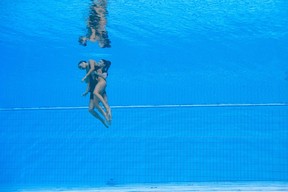 USA’s Anita Alvarez is recovered from the bottom of the pool by a team member after an incident, during the women’s solo free artistic swimming finals during the Budapest 2022 World Aquatics Championships at the Alfred Hajos Swimming Complex in Budapest on June 22, 2022. (Photo by Oli SCARFF / AFP)