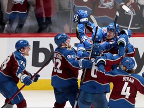 Andre Burakovsky (95) of the Colorado Avalanche celebrates with teammates after scoring a goal against Andrei Vasilevskiy of the Tampa Bay Lightning during overtime to win Game 1 of the 2022 Stanley Cup Final 4-3 at Ball Arena on June 15, 2022 in Denver.