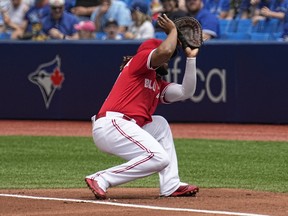Blue Jays first baseman Vladimir Guerrero Jr. ducks out of the way after losing sight of high pop foul in the sun hit by Twins’ Jose Miranda during the first inning yesterday at the Rogers Centre. Given another chance, Miranda then singled home the Twins’ second run of the inning.