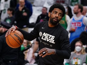 Brooklyn Nets guard Kyrie Irving (11) stares down Boston Celtics fans heckling from the stands before the start of the first round against the Boston Celtics for the 2022 NBA playoffs at TD Garden April 17, 2022.