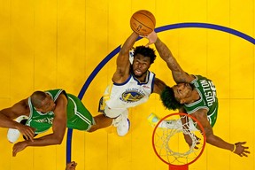Golden State Warriors forward Andrew Wiggins (22) goes for a rebound against Boston Celtics guard Marcus Smart (36) and center Al Horford (42) in game two of the 2022 NBA Finals at the Chase Center on June 5, 2022 ) at. Ezra Shaw/Pool photo -USA TODAY Sport