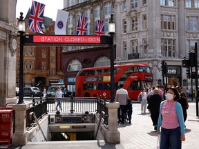 People walk outside Oxford Circus underground station on the first day of national rail strike, in London June 21, 2022.