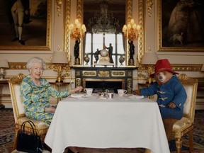 Undated image of Britain’s Queen Elizabeth and Paddington Bear having cream tea at Buckingham Palace taken from a film that was shown at BBC’s Platinum Party at the Palace. Released June 4, 2022.