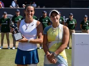France's Caroline Garcia, left, poses with the trophy after winning the 2022 WTA Bad Homburg Open tennis final match nex to Canada's Bianca Andreescu on June 25, 2022 in Bad Homburg, western Germany.