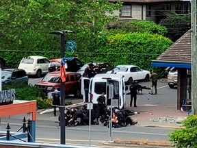 General view of the site where two armed suspects died and six police officers were shot, during an incident at a bank in Saanich, British Columbia, June 28, 2022 in this picture obtained from social media. Joan B Flood/via REUTERS