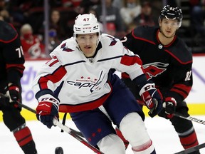 Washington Capitals' Beck Malenstyn (47) chases the puck during the first period of an NHL hockey game in Raleigh, N.C., Sunday, Nov. 28, 2021.