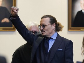 Johnny Depp gestures to spectators in court after closing arguments at the Fairfax County Circuit Courthouse in Fairfax, Va., Friday, May 27, 2022.
