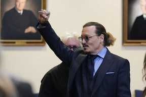 Johnny Depp gestures to spectators in court after closing arguments at the Fairfax County Circuit Courthouse in Fairfax, Va., Friday, May 27, 2022.