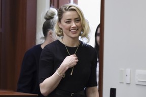 Amber Heard smiles as she arrives before the jury verdict was announced at the Fairfax County Circuit Courthouse in Fairfax, Va, Wednesday, June 1, 2022.