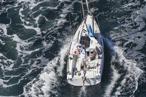 Japan’s Kenichi Horie waves on his sailing boat after his trans-Pacific voyage, at Osaka Bay, western Japan, Saturday, June 4, 2022. (Kyodo News via AP)