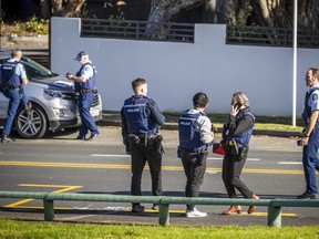 Police set up cordons and search area around a suburb of Auckland following reports of multiple stabbings, in New Zealand, Thursday, June 23, 2022.