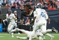 BC Lions' James Butler jumps over the tackle of Toronto Argonauts' Royce Metchie during first half of CFL football action in Vancouver, B.C., Saturday, June 25, 2022.