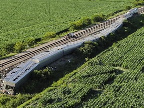 An Amtrak train lies derailed after the train hit a truck at a crossing, Monday, June 27, 2022, near Mendon, Mo. (Jill Toyoshiba/The Kansas City Star via AP)