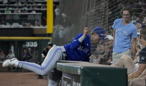 Blue Jays first baseman Cavan Biggio attempts to catch a foul ball hit by White Sox third baseman Jake Burger during the fifth inning at Guaranteed Rate Field in Chicago on Monday, June 20, 2022.