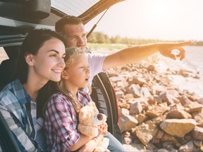 Happy family on a road trip in their car.