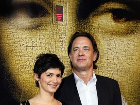 French actress Audrey Tautou (L) and US actor Tom Hanks pose upon arriving at the Cannes train station, southern France, 16 May 2006,  on the eve of the  start of the 59th edition of the Cannes Film Festival. (Photo credit should read VALERY HACHE/AFP via Getty Images)