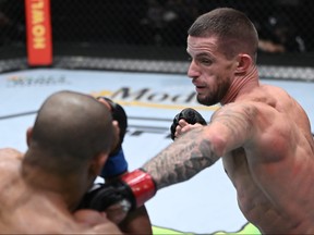 In this handout photo provided by UFC, (R-L) Nate Maness punches Tony Gravely in a bantamweight fight during the UFC Fight Night event at UFC APEX on September 18, 2021 in Las Vegas, Nevada.