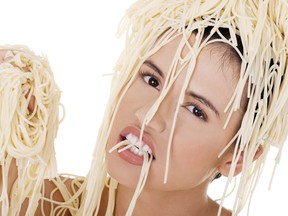Young woman having spaghetti