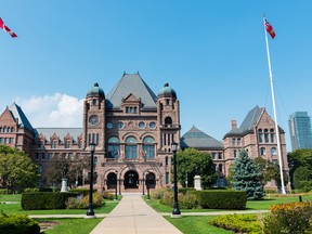 Legislative Assembly of Ontario at Queen's Park on a clear summer day in Toronto.