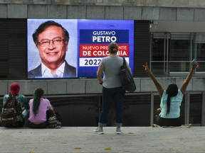 People watch a screen showing the preliminary results of the second round of the presidential election in Medellin, Colombia, June 19, 2022.
