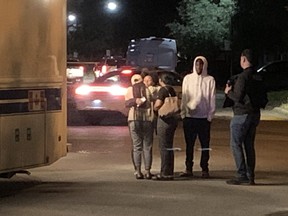 People hug near the scene of a fatal shooting in Mississauga on Wednesday, June 22, 2022.