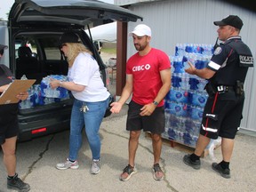 Project Water's founder Jody Steinhauer helps volunteers load up a van with donated water for the GTA homeless in over 200 locations.