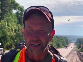 James Topp, an armed forces reservist who lost his job for refusing to be vaccinated and has walked across Canada to protest COVID-19 mandates, arrives near Mattawa on June 20, 2022.