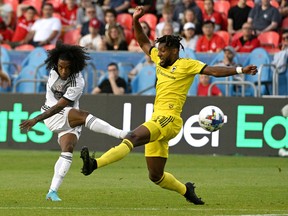 Toronto FC midfielder Jayden Nelson (left) shoots the ball past Columbus Crew defender Steven Moreira  in the first half at BMO Field on Wednesday night.