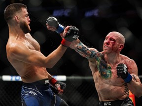 Calvin Kattar, left, and Josh Emmett exchange strikes during their featherweight fight at the UFC Fight Night event at Moody Center on June 18, 2022 in Austin, Texas.