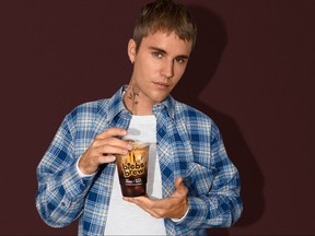 Justin Bieber with the Biebs Brew iced coffee available Monday at Tim Hortons.