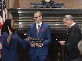 In this handout provided by the U.S. Supreme Court, Chief Justice John G. Roberts, Jr. (right) administers the Constitutional Oath to Judge Ketanji Brown Jackson (left) in the West Conference Room of the Supreme Court in Washington, D.C., on Thursday, June 30, 2022.