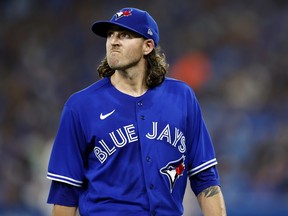 Kevin Gausman of the Toronto Blue Jays leaves the field in the third inning after being called out of the game during an MLB game against the Baltimore Orioles at Rogers Center on June 16, 2022 in Toronto.